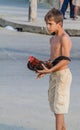 CIENFUEGOS, CUBA - FEBRUARY 10, 2016: Young boy with a rooster in Cienfuegos, Cub