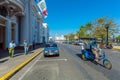 CIENFUEGOS, CUBA - MARCH 30, 2012: Bicycle taxis and pedestrians