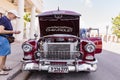 CIENFUEGOS, CUBA - MARCH 11, 2018 Red Chevrolet 350 fitfyfive - 1955 Chevy Nomad Restomod. View under the front bonnet on the engi Royalty Free Stock Photo