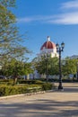 CIENGUEGOS, CUBA - JANUARY 10 2021: Cienfuegos Jose Marti central park with palms and historical buildings, Cienfuegos