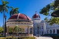 CIENGUEGOS, CUBA - JANUARY 10 2021: Cienfuegos Jose Marti central park with palms and historical buildings, Cienfuegos