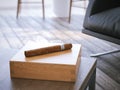 Cigar and humidor on the wooden table. 3d rendering