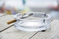 Cigarette and ashtray on wooden table