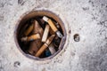 Cigarette butts in pole hole Royalty Free Stock Photo