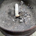 cigarette butts in a wooden ashtray Royalty Free Stock Photo