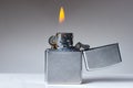 Cigarette lighter with flame on white and grey background Royalty Free Stock Photo