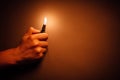 Cigarette lighter igniting by a hand