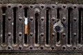 Cigarette in a rusty sewer grid