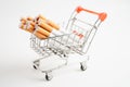 Cigarette in shopping cart, cost, trading, marketing and production, No smoking concept Royalty Free Stock Photo