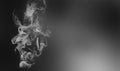 Cigarette smoke over blacl wall. Healthcare nonsmoking addictions concept. Abstract background for posters and flyers