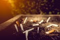 cigarettes and ash on sand in trash tray Royalty Free Stock Photo