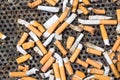 Cigarettes in a big iron ashtray Royalty Free Stock Photo