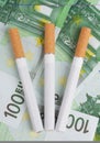 Cigarettes lying on the bills Royalty Free Stock Photo