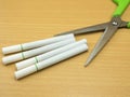 Cigarettes on wooden background with Scissors concept stop smoke Royalty Free Stock Photo