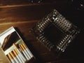 Cigars and ashtray on table.