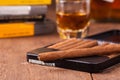 Cigars and whisky on old wooden table Royalty Free Stock Photo