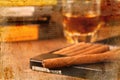 Cigars and whisky on old wooden table. Royalty Free Stock Photo