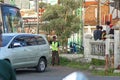 A parking attendant who is helping a car driver to give directions in parking his car