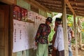 Several residents are looking at examples of election papers that stand for the general election for the new president of the