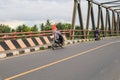 a small child who is riding a motorbike with his father but in a standing position and this is dangerous Royalty Free Stock Photo