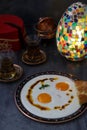 Cilbir, eggs in yogurt with spiced butter and herbs, served with bread and tea, turkish cuisine, copy space