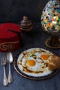Cilbir, eggs in yogurt with spiced butter and herbs, served with bread and tea, turkish cuisine, copy space