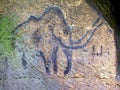 Cildren art in sandstone cave. Black carbon mammoth paint Royalty Free Stock Photo