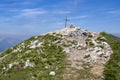Cima delle Pozzette, A cross on the top of a mountain, turistic train Alta Via del Monte Baldo Royalty Free Stock Photo