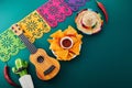 Cinco de mayo celebration concept. Cactus, maracas and sombrero hat on tilt green background