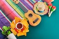 Cinco de mayo celebration concept. Cactus, maracas and sombrero hat on tilt green background