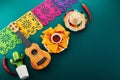 Cinco de mayo celebration concept. Cactus, maracas and sombrero hat on tilt green background