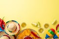 Top flat lay photo of mexican sombrero colorful poncho maracas tequila shots lime chili pepper nacho chips sauce salsa Royalty Free Stock Photo