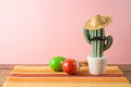 Cinco de Mayo holiday background with Mexican cactus,  party sombrero hat and maracas on wooden table Royalty Free Stock Photo