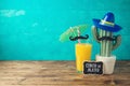 Cinco de Mayo holiday background with Mexican cactus, party sombrero hat and orange juice Royalty Free Stock Photo