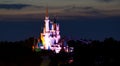 Cinderella's Castle lit up in rainbow colors.