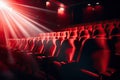 Cinema auditorium with red seats and spotlights. Cinema background, Bright empty red seats in cinema rows, AI Generated