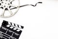 Cinema background with movie clapperboard and film reel Royalty Free Stock Photo