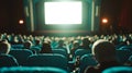 Cinema blank screen and people in blue chairs in the cinema hall. Blurred People silhouettes watching movie performance