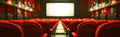 Cinema blank screen and people in red chairs in the cinema hall. Blurred People silhouettes watching movie performance