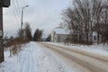 Cinema building in the park. Abandoned Winter road. Badly cleaned. A lot of snow.