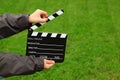 Cinema clapper board in hands of boy Royalty Free Stock Photo