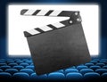 Cinema clapper board on movie screen blue audience Royalty Free Stock Photo