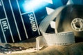 Cinema clapper and video film negative movie on a rough cloth. Royalty Free Stock Photo