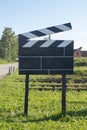 Cinema Concept Big Size Movie Clapper at Ourside on Green Grasses at Outside Royalty Free Stock Photo