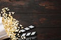 Cinema concept. Popcorn in a box and movie clapper on wooden background top view. Free space Royalty Free Stock Photo