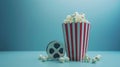 Cinema concept of vintage film reel with popcorn on blue background Royalty Free Stock Photo