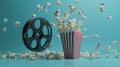 Cinema concept of vintage film reel with popcorn on blue background Royalty Free Stock Photo