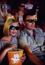 Cinema, 3d glasses and couple with popcorn, watching film or eating on romantic date together. Movie night, man and Royalty Free Stock Photo