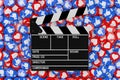 Cinema Director Clapper over Heap of Social Media Network Love and Like Heart Badges Coins Background Texture. 3d Rendering