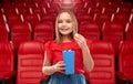 Smiling girl eating popcorn at movie theater Royalty Free Stock Photo